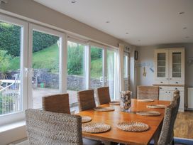 A dining room with a table and chairs at Dolphins in Salcombe