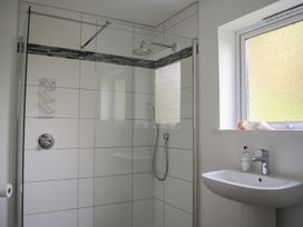 A bathroom with a shower and sink at Dolphins in Salcombe