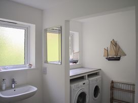 A laundry room with a sink and washing machines at Dolphins in Salcombe