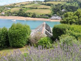 A view of the beach and sea with greenery and lavender at Edinburgh House in Salcombe