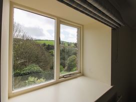 A window with a view of greenery at Orchard Barn Salcombe