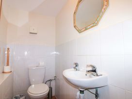 A bathroom with a toilet and sink at Orchard Barn Salcombe