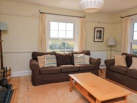 A living room with a sofa and coffee table at Savernake in Thurlestone
