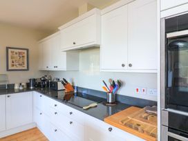 A kitchen with cabinets and appliances at Savernake in Thurlestone