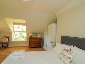 A bedroom with a bed and a dresser at Savernake in Thurlestone