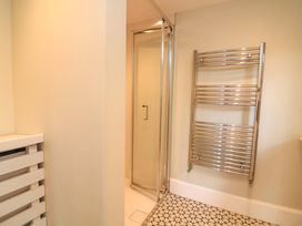 A bathroom featuring a shower and towel radiator at Savernake in Thurlestone