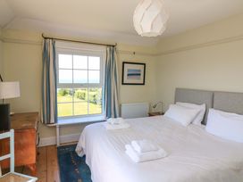 A bedroom with a bed and window at Savernake Thurlestone