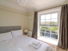 A bedroom with a bed and window at Savernake Thurlestone