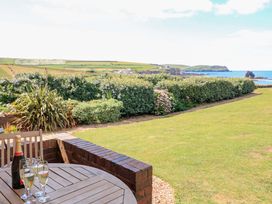 A table with glasses and a bottle of champagne in the garden at Savernake Thurlestone