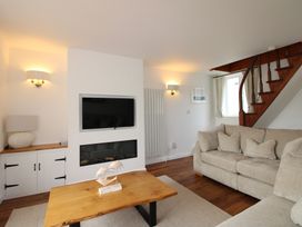 A living room with a television and sofa at Seagulls in Salcombe