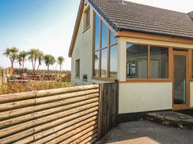 A house with a fence and palm trees at The Station in Bolberry