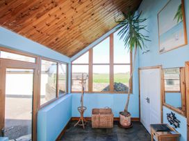 An entrance hall with a coat rack and plant at The Station in Bolberry