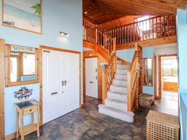 A hallway with stairs and mirrors at The Station in Bolberry