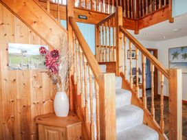 An entryway with stairs and a vase of flowers at The Station in Bolberry