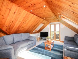 A living room with two sofas and a television at The Station in Bolberry