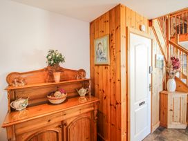 A hallway with a wooden cabinet and decorative items at The Station in Bolberry