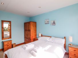 A bedroom with a bed and wardrobe at The Station in Bolberry