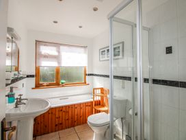 A bathroom with a sink, toilet, shower, and bathtub at The Station in Bolberry