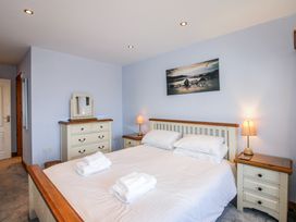 A bedroom with a bed and nightstands at The Station in Bolberry