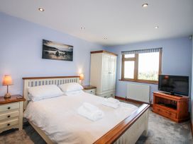 A bedroom with a double bed and a wardrobe at The Station in Bolberry