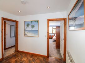A hallway with a painting and doors at The Station in Bolberry