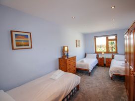 A bedroom with three beds and a dresser at The Station in Bolberry
