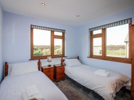 A bedroom with two beds and windows at The Station in Bolberry