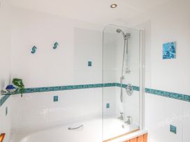 A bathroom with a bathtub and shower at The Station in Bolberry