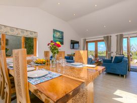 A dining room with a table and chairs at Mellydonen Beder Del (Melly), Tor Down Quarry, St Breward