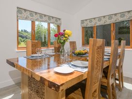 A dining room with a wooden table and chairs at Mellydonen Beder Del (Melly), Tor Down Quarry, St Breward