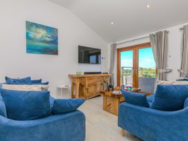 A living room with a television and sofa at Mellydonen Beder Del (Melly), Tor Down Quarry, St Breward