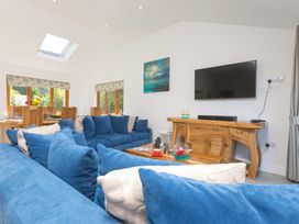 A living room with a television and sofa at Mellydonen Beder Del (Melly), Tor Down Quarry, St Breward