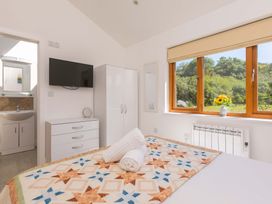 A bedroom with a bed and television at Mellydonen Beder Del (Melly), Tor Down Quarry in St Breward