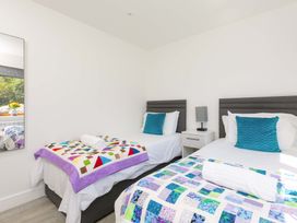 A bedroom with two beds and a mirror at Mellydonen Beder Del (Melly), Tor Down Quarry, St Breward