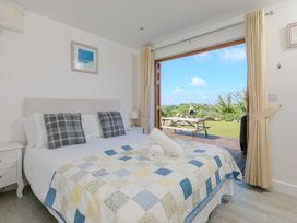 A bedroom with a bed and outdoor view at Mellydonen Beder Del (Melly), Tor Down Quarry, St Breward