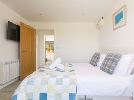 A bedroom with a bed and television at Mellydonen Beder Del (Melly), Tor Down Quarry, St Breward