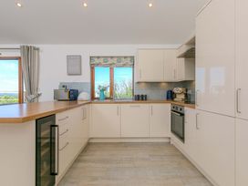 A kitchen with appliances and a window at Mellydonen Beder Del (Melly), Tor Down Quarry in St Breward