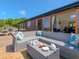 An outdoor seating area with a sofa and coffee table at Mellydonen Beder Del (Melly), Tor Down Quarry St Breward