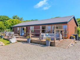 A house with a deck and outdoor seating at Mellydonen Beder Del (Melly), Tor Down Quarry St Breward