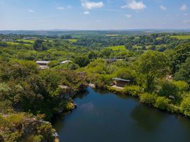 A scenic view of a lake and greenery at Mellydonen Beder Del (Melly), Tor Down Quarry St Breward