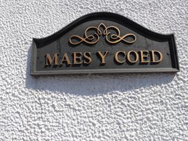 A sign reading Maes Y Coed