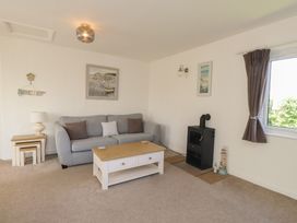 A living room with a sofa and coffee table at Maes Y Coed in Morfa Nefyn