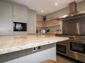 A kitchen with an island and appliances at Postcard Lodge in Polruan