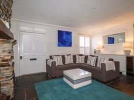 A living room with a sofa and coffee table at Rock House in Trebarwith Strand near Tintagel
