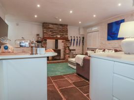 A living room with a sofa and fireplace at Rock House near Trebarwith Strand near Tintagel