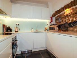 A kitchen with appliances and utensils at Rock House Trebarwith Strand near Tintagel