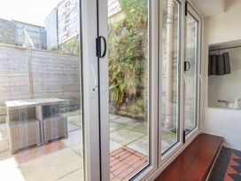 A snug with a glass door opening to a garden at Rock House Trebarwith Strand near Tintagel