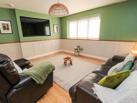 A living room with a television, sofas and a coffee table at The Old Dairy Cotleigh near Honiton