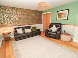 A living room with a sofa and armchair at The Old Dairy Cotleigh near Honiton