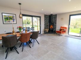 A dining room with a table and chairs at The Old Dairy Cotleigh near Honiton